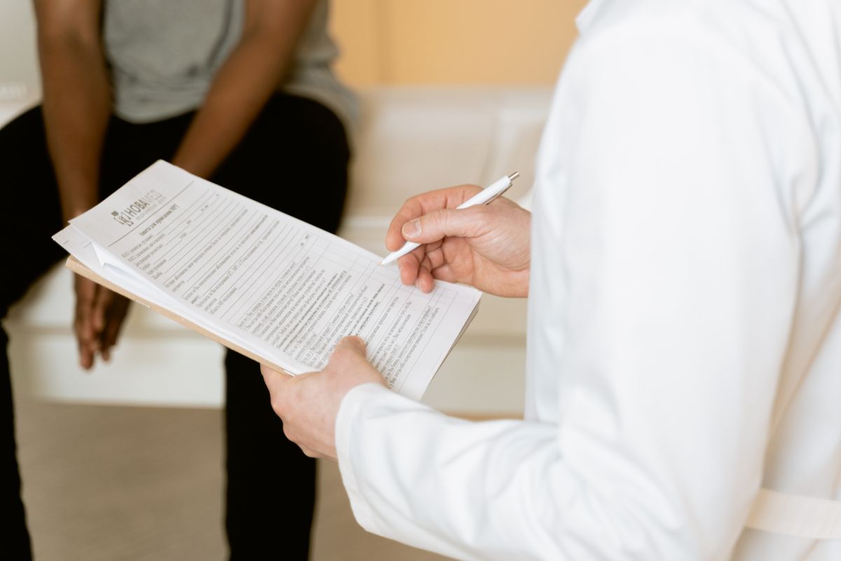 A healthcare professional reviewing a medical form during a case consultation
