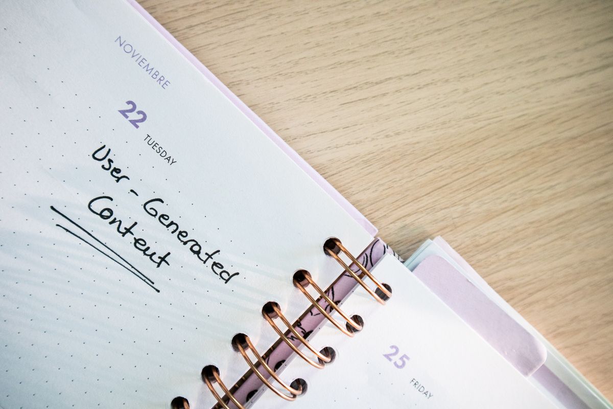 An open planner with handwritten scheduling notes on a desk